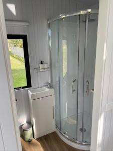 a bathroom with a shower and a sink at The Coast 2 