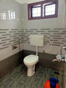 a bathroom with a toilet and a shower at Silver Munnar in Munnar