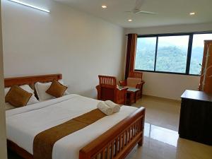 a bedroom with a bed and a large window at Silver Munnar in Munnar