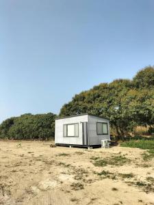 a tiny house sitting on top of a field at The Dawn 2 in Kaohsiung