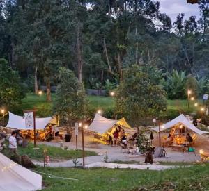 a group of tents in a park at night at Sungai Tiny House in Raub