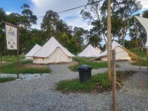 a group of tents parked in a gravel lot at Sungai Tiny House in Raub