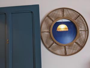 a mirror hanging on a wall next to a door at La Maison du Cosquer in Camaret-sur-Mer