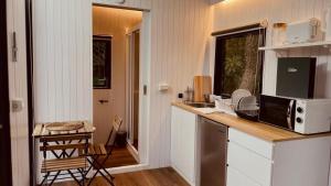 a kitchen with a counter top with a microwave at Gandan Inn in Douliu