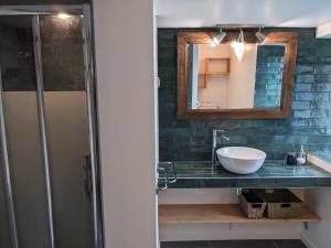 a bathroom with a sink and a mirror at La Maison du Cosquer in Camaret-sur-Mer