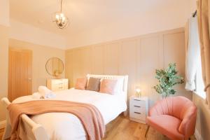a small bedroom with a bed and a chair at Northern Hideaways, Eider Cottage, Seahouses in Seahouses +49 photos