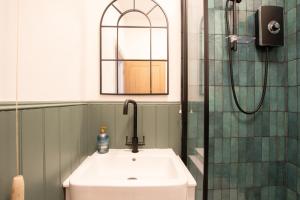 a bathroom with a sink and a shower at Northern Hideaways, Eider Cottage, Seahouses in Seahouses