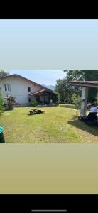 two pictures of a yard with a house at Villa Franca casa immersa nel verde in Villa dʼAiano