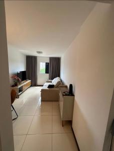 a living room with a bed and a couch at Apartamento próximo a praia in Maceió