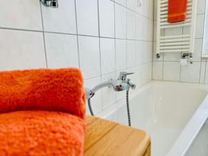 a bathroom with a bath tub with a faucet at Ferienwohnung Haus Feig in Geyer