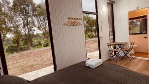 a bedroom with a bed and a view of a yard at Gandan Inn3 in Douliu