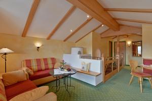 a living room with a couch and a table at Landhaus Schwentner in Kössen