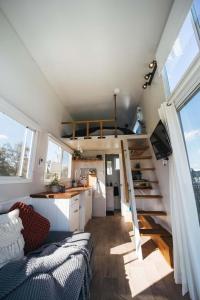 a tiny house with a staircase and a kitchen at Malniri Park in Wilberforce