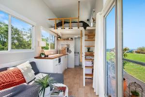 a tiny house with a kitchen and a living room at Malniri Park in Wilberforce