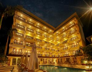 a hotel with a swimming pool at night at Resort De Coracao - Calangute , Goa in Calangute
