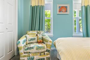 a room with a chair and a bed and a window at Southern Charm in Foley
