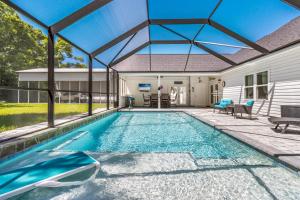 an indoor swimming pool with a large glass roof at Southern Charm in Foley