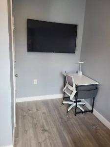 a desk and a chair in a room with a flat screen tv at Spacious Retreat in Carbondale