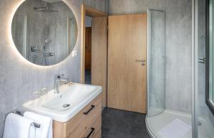a bathroom with a sink and a shower and a mirror at Hotel Seestern in Wasserburg