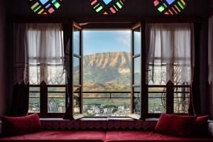 a room with a window with a view of a mountain at Guesthouse Hoxha in Gjirokastër