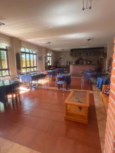 a dining room with tables and chairs and a room with a table at Hotel Gavitu in Celorio