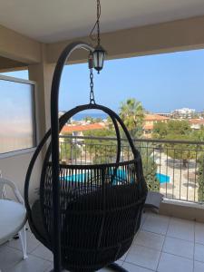 a basket swing hanging from a balcony with a view at Newly renovated- Regina Gardens 1, Venus Beach 500 m, Sea&Sunsets view, license ooo7141 in Paphos City