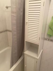 a bathroom with a white cabinet and a tub and a shower at Newly renovated- Regina Gardens 1, Venus Beach 500 m, Sea&Sunsets view, license oo12075 in Paphos +24 photos