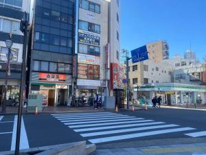 a city street with a crosswalk in front of buildings at tokyo Large family vacation rentals in Tokyo
