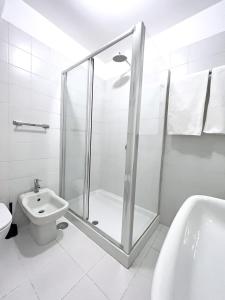 a bathroom with a shower and a toilet and a sink at Trevi over the top apartment in Rome