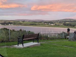 a park bench with a view of a body of water at Serenity Ballycastle in Ballycastle