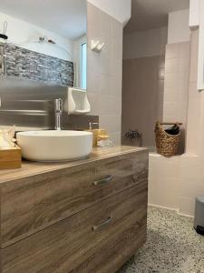 a bathroom with a sink and a shower at Apartment near Piraeus’ port in Piraeus