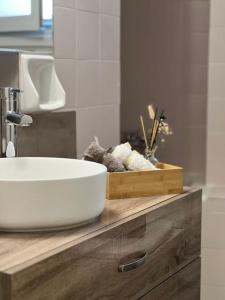 a bathroom counter with a white sink on top of it at Apartment near Piraeus’ port in Piraeus