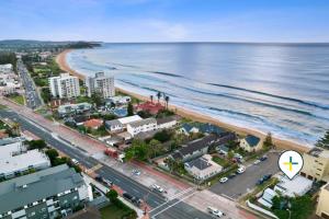 an aerial view of a beach and the ocean at Beachside Magic - Footsteps to the Beach in Narrabeen