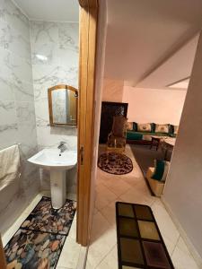 a bathroom with a sink and a mirror at Annour Luxurious & Large apartment in Oujda Centre in Oujda