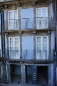 an apartment building with a balcony on the side at Alfandega Apartments in Porto