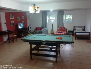 a living room with a pool table in it at Geralis Lodge in Chalkida