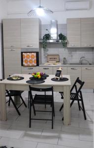 a kitchen with a table with fruits on it at Capodichino Hause in Naples