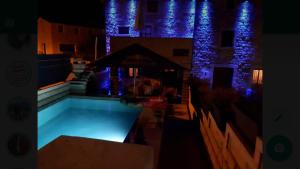 a swimming pool in front of a building at night at Stone House Istria HRIS 1 in Baderna
