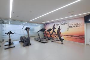 a gym with treadmills and exercise equipment in a room at Don Gregory by Dunas - Adults Only in San Agustin