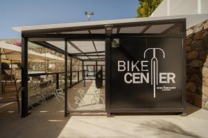 a bus shelter with a bike center sign on it at Don Gregory by Dunas - Adults Only in San Agustin