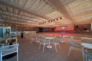 a large room with tables and chairs and a tennis court at Don Gregory by Dunas - Adults Only in San Agustin