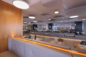 a restaurant with tables and chairs and a counter at Don Gregory by Dunas - Adults Only in San Agustin