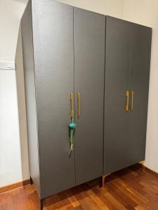 a pair of gray storage cabinets with yellow handles at REIZZ RESIDENCE BY BERJAYA in Kuala Lumpur