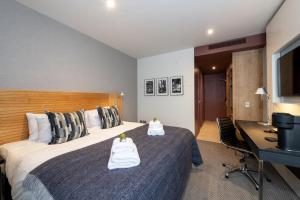 a hotel room with a bed and a desk at Apex City of Edinburgh Hotel in Edinburgh