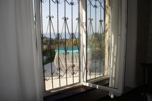 an open door to a balcony with a table at Гостевой дом на Санаторной in Sochi