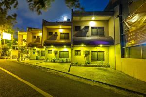 an empty street in front of a building at night at Palazzo Pensionne in Cebu City