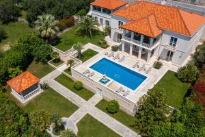 an aerial view of a house with a swimming pool at La Villa Dubrovnik in Trsteno