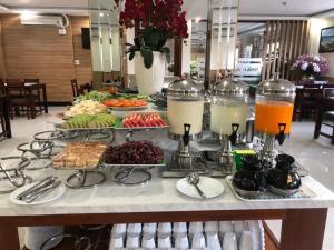 a buffet of food and drinks on a table at Flora Quy Nhon Hotel in Quy Nhon