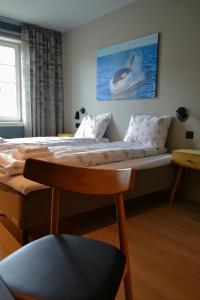 Ένα ή περισσότερα κρεβάτια σε δωμάτιο στο Andenes Suitehotel