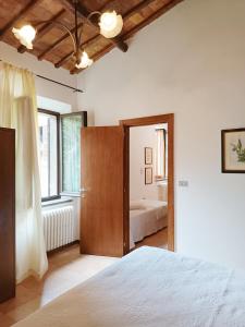 1 dormitorio con 1 cama y puerta abierta en Casa con Giardino Pieno Centro Storico a Due Passi dal Duomo, en Orvieto